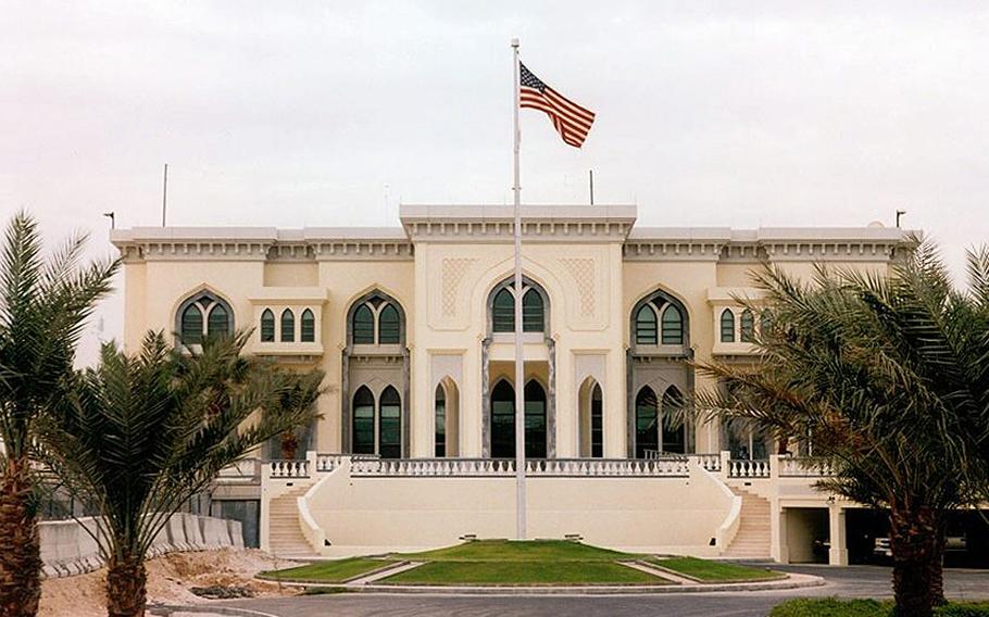 A view of the U.S. Embassy in Qatar, with the American flag flying in front.