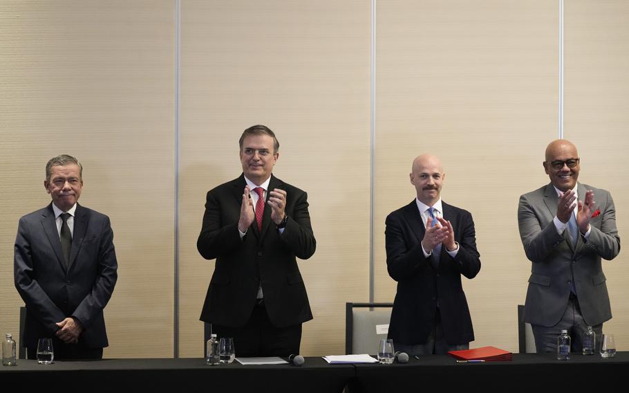 From left, Venezuelan opposition delegate Gerardo Blyde Perez, Mexico’s Foreign Minter Marcelo Ebrad, Norwegian diplomat Dag Nylander and President of the National Assembly of Venezuela, Jorge Rodriguez, applaud after signing an agreement to create a U.N.-managed fund to finance health, food and education programs for the poor during a ceremony at a hotel in Mexico City, Saturday, Nov. 26, 2022. The agreement signed by representatives of Venezuelan President Nicolás Maduro and the opposition marked the resumption of long-stalled negotiations meant to find a common path out of their country’s complex crisis. The U.S. government, in response, agreed to allow oil giant Chevron to pump Venezuelan oil. 