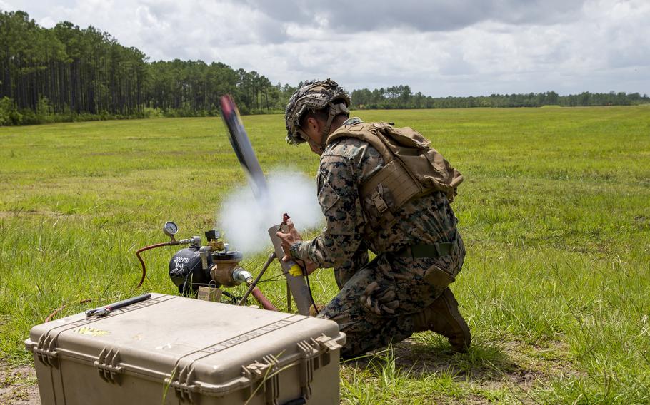 U.S. Marine Corps Lance Cpl. Isiah Enriquez, a native of Lubbock, Texas, and a rifleman with 1st Battalion, 2d Marine Regiment (1/2), 2d Marine Division (2d MARDIV), launches a Switchblade Drone during a training exercise at Camp Lejeune, N.C., July 7, 2021. 1/2 is tasked as 2d MARDIV’s experimental infantry battalion to test new gear, operating concepts and force structures. The unit’s findings will help refine infantry battalions across the Marine Corps in accordance with Force Design 2030. 