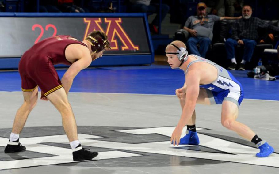 Air Force Academy cadet Tanner Johnson, right, wrestles against a University of Minnesota athlete in 2018. He continued wrestling competitively after he was diagnosed with Type 1 diabetes at the start of his senior year.