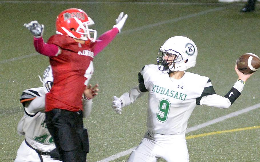 Kubasaki quarterback Caleb Stephan tries to get rid of the ball as Nile C. Kinnick's Vian Barrera homes in.