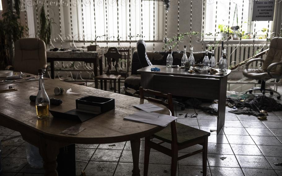 Bottles of alcohol are seen in a main room of a building occupied by Russian forces. 