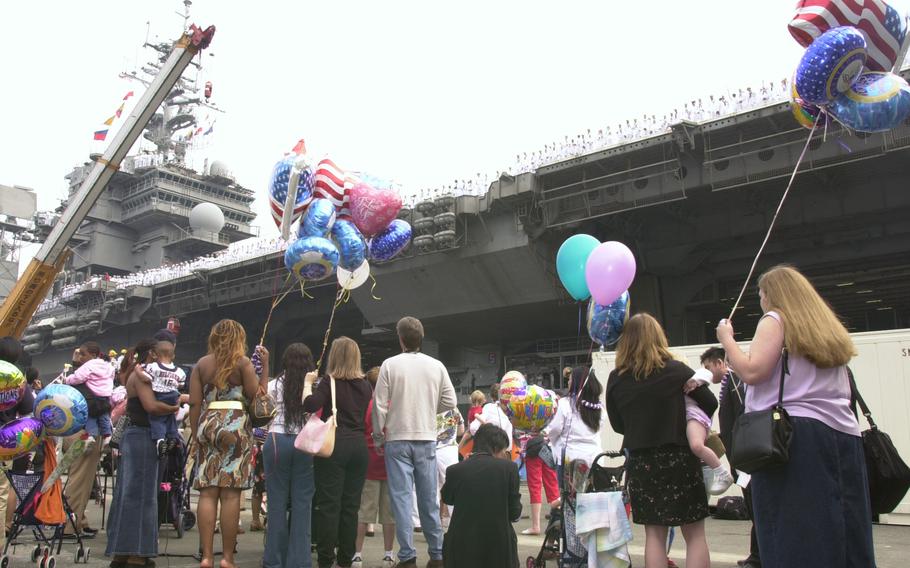 Family members wait anxiously on the pier as the USS Kitty Hawk  returns from the Persian Gulf. 
