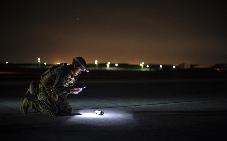 Marine Staff Sgt. Keith Lowe, of Marine Wing Support Squadron 171 , works to identify unexploded ordnance after a mock attack on the flight line during an Active Shield drill at Marine Corps Air Station Iwakuni, Japan, Oct 27, 2021. 