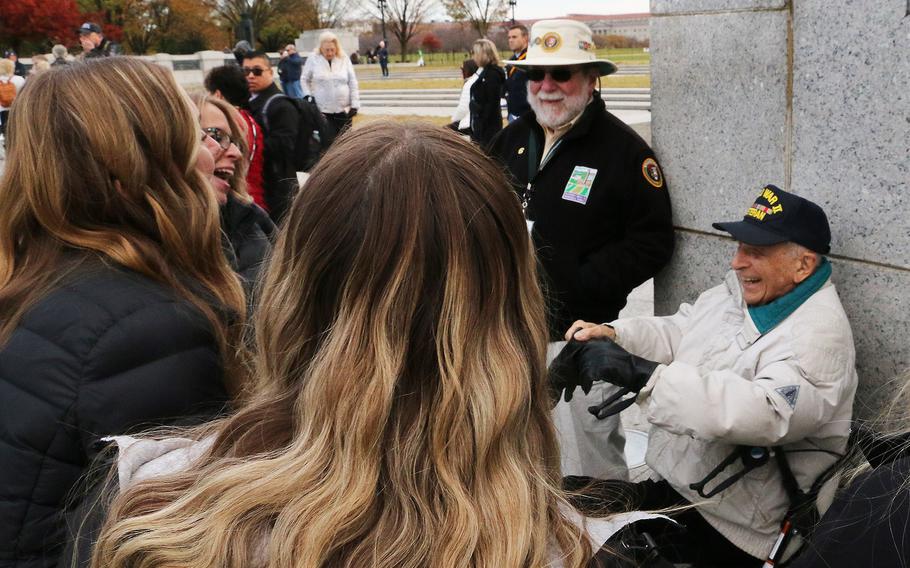 World War II veteran Frank Cohn talks to kids before the Veterans Day ceremony at the National World War II Memorial in Washington, November 11, 2023.