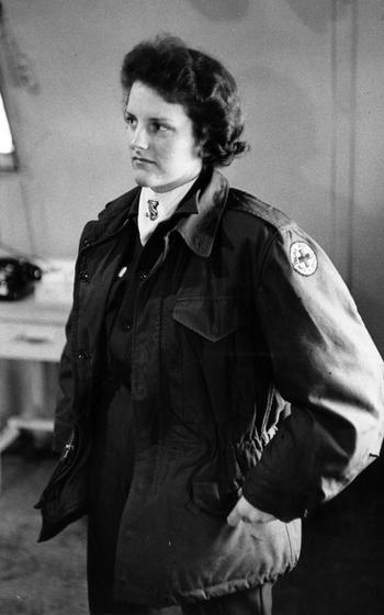 A woman stands in uniform