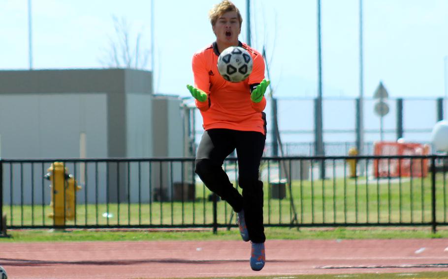 Matthew C. Perry goalkeeper Kirby Kendrick goes up for a save against Nile C. Kinnick during Saturday's DODEA-Japan boys soccer match. The Red Devils won 6-0.