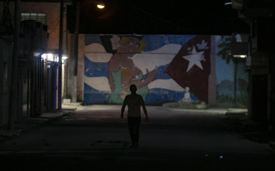 A pedestrian walks down a street during a rolling blackout in Havana on March 26, 2024. Frustration with the economic crisis prompted rare protests this month.