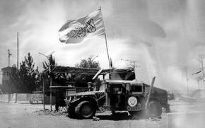 A Taliban flag waves from a U.S. military vehicle which had been used during the years of military intervention, on the outskirts of Kabul, Afghanistan, Tuesday, June 21, 2023.