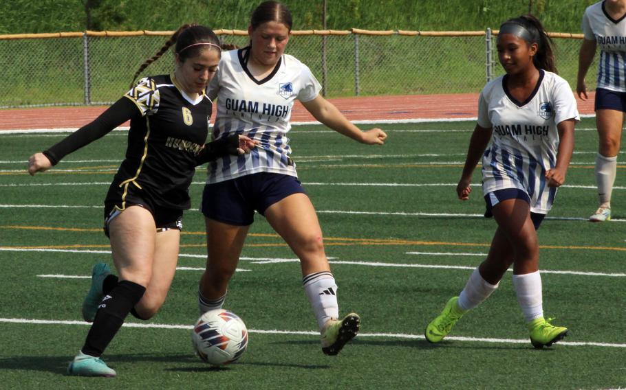 Humphreys' Elyanna Koch dribbles against a pair of Guam High defenders.