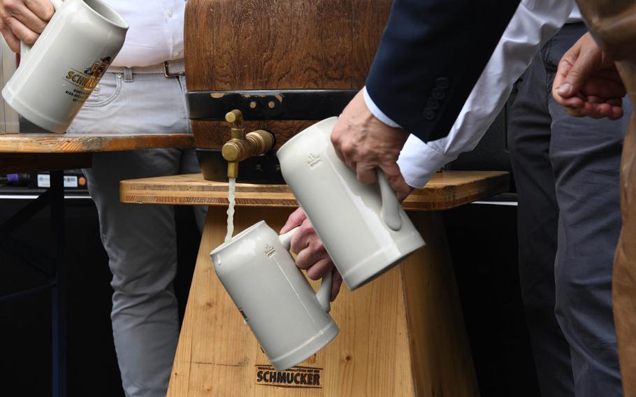 Beer is poured from a keg opened by Col. David Mayfield, the commander of U.S. Army Garrison Wiesbaden, to mark the official start of the German-American Friendship Festival at the Hainerberg housing area, June 29, 2023.