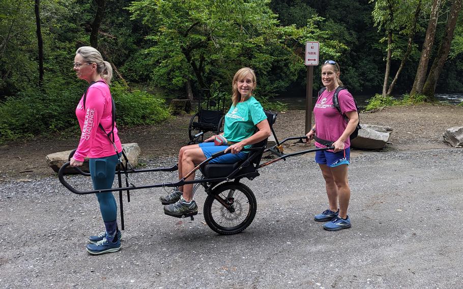 Participants attend a hike in Great Smoky Mountains National Park using the Joëlette, an all-terrain wheelchair with a single wheel. 