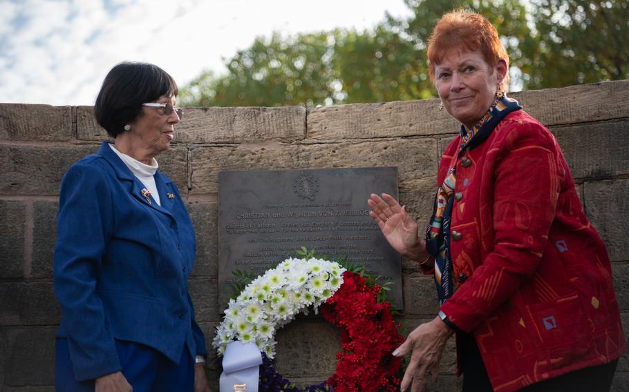 Retired Defense Department teacher Carol Moldenhauer, left, and retired Army Lt. Col. Lois Borsay — both members of the Daughters of the American Revolution — lay a wreath on a plaque unveiled in Zweibrucken, Germany, to commemorate the Regiment Royal Deux-Ponts, Saturday, Oct. 29, 2022.