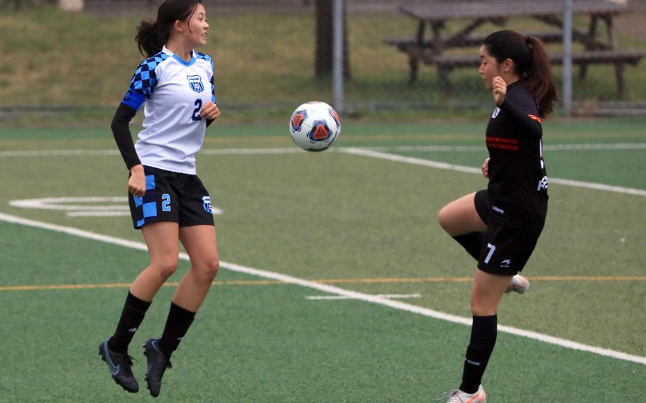 Osan's Vivian Machmer and Seoul Foreign's Jihoo Yang scuffle for the ball during Wednesday's Korea girls soccer match. The Crusaders won 5-1.