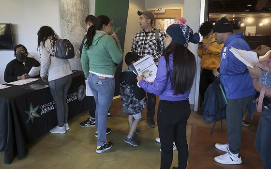 Migrants line up to obtain city identification from city employees at Park Community Church on April 26, 2023. (Antonio Perez/Chicago Tribune/TNS)
