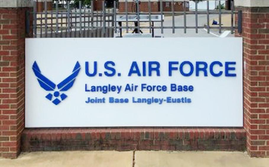 A white entrance sign with a brick border reading in blue lettering “U.S. Air Force Langley Air Force Base.”