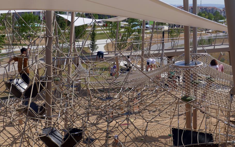 Children play on a huge rope jungle gym at the  Bundesgartenschau, the German federal horticultural show in Mannheim, Germany, in June 2023. While probably more interesting for adults, there is plenty for the kids to do on the shows expansive grounds.