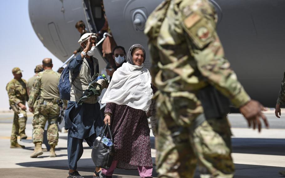 Afghan evacuees leave a U.S. C-17 Globemaster III after arriving at Ali Al Salem Air Base, Kuwait, Aug. 26, 2021. Lawmakers in the Senate removed language extending the Special Immigrant Visa program past 2023 from the text of the National Defense Authorization Act, potentially spelling the end to the program that assisted thousands of Afghan refugees to escape Taliban rule.