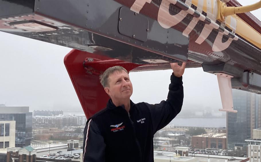 Scott Nance, one of the pilots who flies the Nightingale air ambulance from Sentara Norfolk General Hospital, checks the chopper.