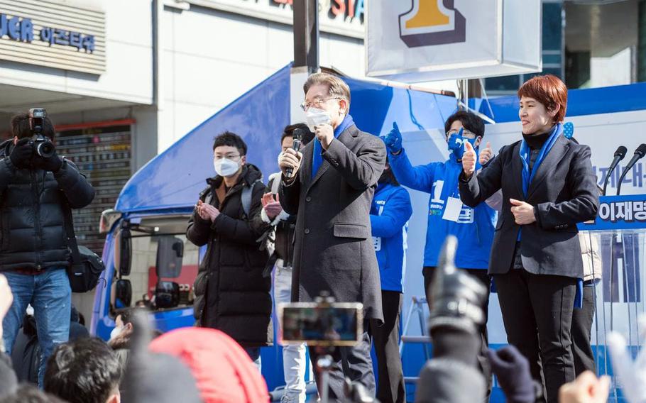 South Korean Democratic Party presidential nominee Lee Jae-myung, center, speaks during a campaign stop in Gangnam, South Korea, Wednesday, Feb. 16, 2022. 