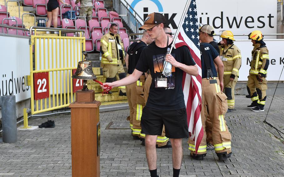 Army Pfc. Charles Adam rings the bell signaling the completion of the 9/11 Stair Climb on Sept. 11, 2023, at Fritz Walter Stadium in Kaiserslautern, Germany.