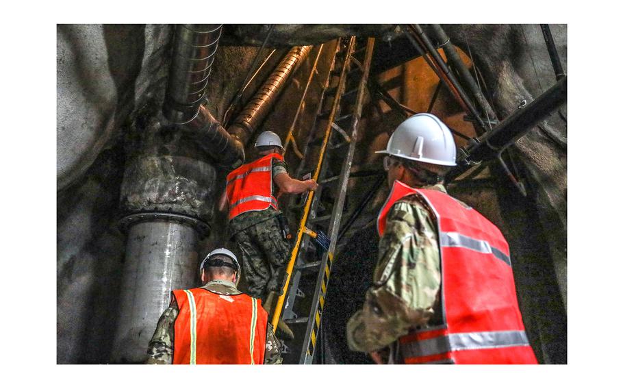 Joint Task Force-Red Hill communications directorate personnel climb a ladder in the Red Hill Bulk Fuel Storage Facility, Halawa, Hawaii, on Sept. 14, 2023. 