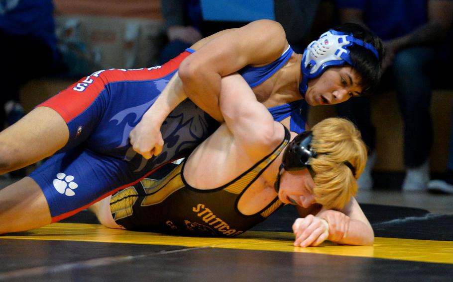 Ramstein’s Joshua Conway puts the pressure on Stuttgart’s Aidan Morgan in the 126-pound final at the DODEA-Europe wrestling championships, in Wiesbaden, Germany, Feb. 11, 2023. Conway took the title.