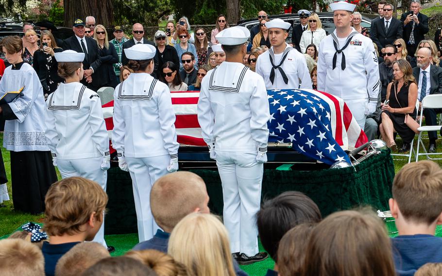 Navy Reserve Center funeral honor detail sailors stand at attention around retired Lt. Cmdr. Lou Conter’s casket during his memorial service.