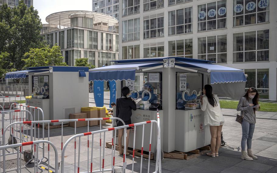 Residents at a coronavirus testing booth in Beijing, China, on Aug. 30, 2022. 