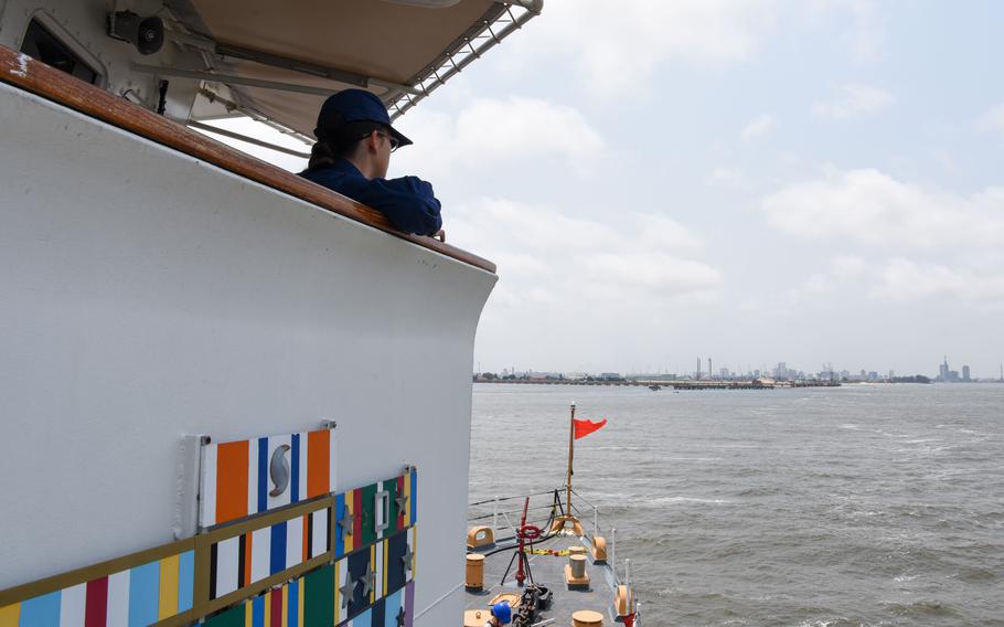 U.S. Coast Guard Petty Officer 3rd Class Annabelle Touchton, an electronics technician aboard USCGC Mohawk, stands lookout before arriving in Lagos, Nigeria, Aug. 18, 2022. 