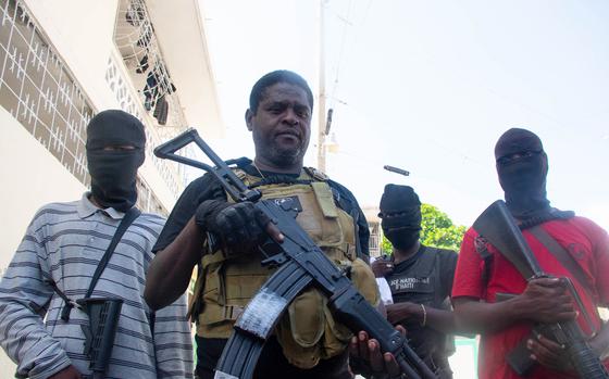 Armed gang leader Jimmy "Barbecue" Cherisier and his men are seen in Port-au-Prince, Haiti, on March 5, 2024. Armed gangs today control more than 80% of the capital. (Clarens Siffroy/AFP/Getty Images/TNS)
