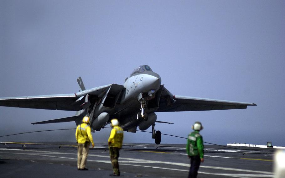 An F-14 Tomcat from VF-154 snags an arresting wire as it touches down on the flight deck of the USS Kitty Hawk on Monday, April 15, 2002. With this touchdown, several days of carrier qualifications followed.