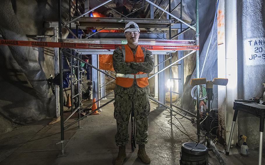 Petty Officer 1st Class Brian Raposa, a Damage Controlman currently assigned to Joint Task Force-Red Hill stands inside a tunnel at Red Hill Bulk Fuel Storage Facility in Halawa, Hawaii, on Mar. 3, 2023. 