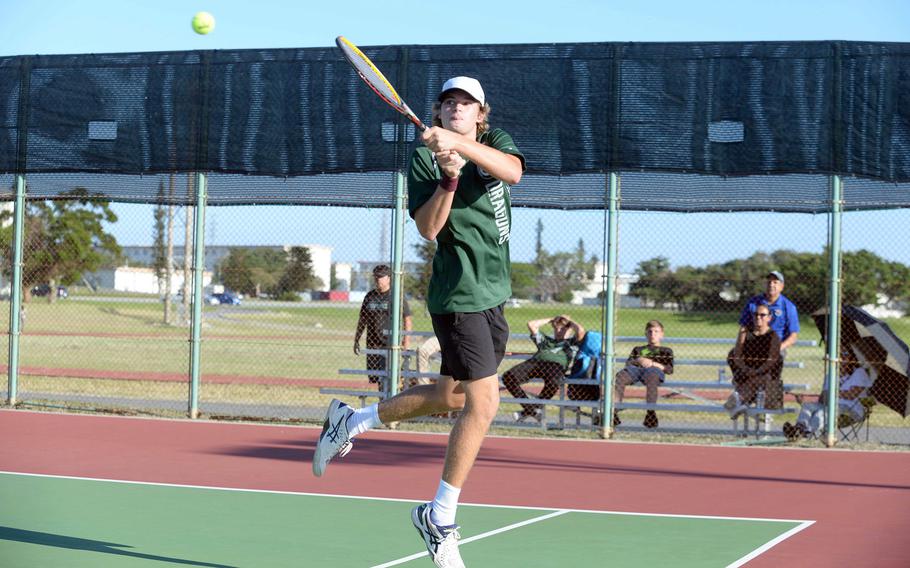 Kubasaki's Owen Ruksc hits a backhand return during his boys singles semifinal victory over Kadena's Gabriel Fino.