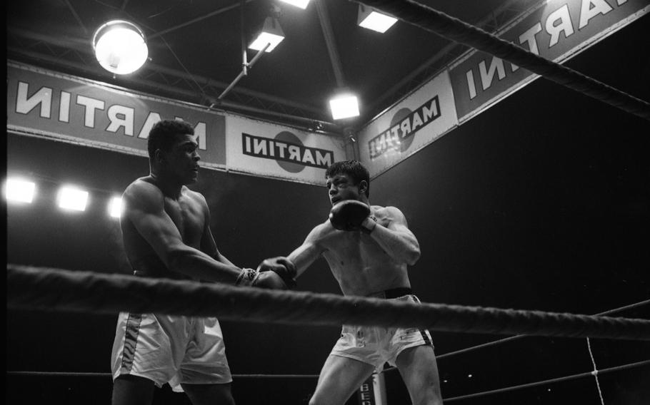 European champion Karl Mildenberger of Germany — face battered and shorts bloodied — keeps going after defending world heavyweight champion Muhammad Ali. Despite being knocked down three times in the 12-round bout, Mildenberger showed impressive stamina and while Ali successfully defended his world title with a TKO decision in the 12th round; he would say his opponent “gave me the toughest title defense I’ve had so far.”