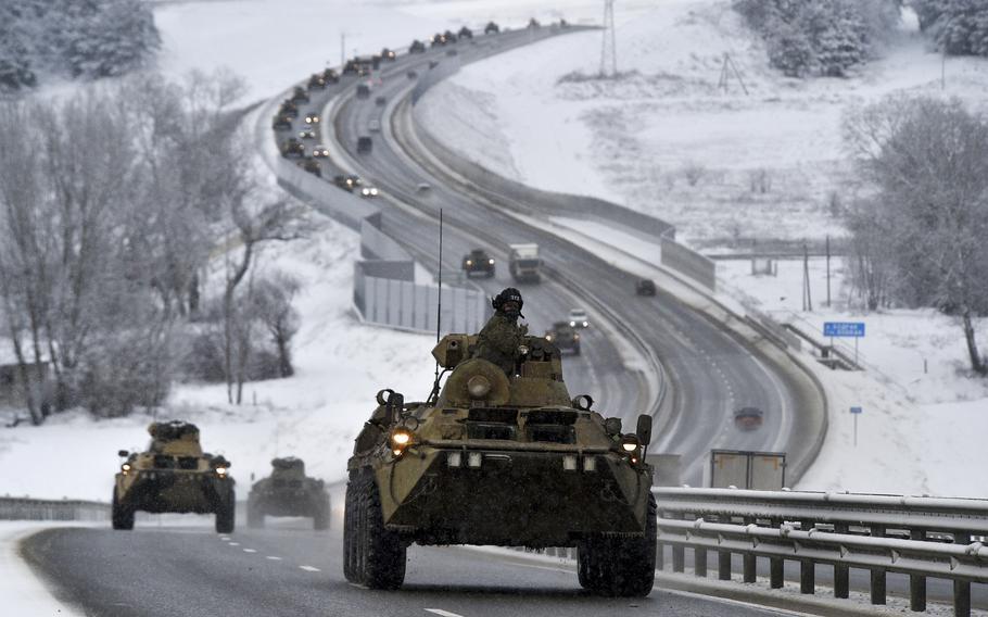 A convoy of Russian armored vehicles moves along a highway in Crimea, on Tuesday, Jan. 18, 2022. Russia has concentrated an estimated 100,000 troops with tanks and other heavy weapons near Ukraine in what the West fears could be a prelude to an invasion. 