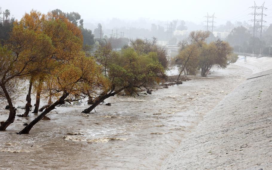 Rain falls, and the Los Angeles River flows on Jan. 9, 2023, in Los Angeles. 