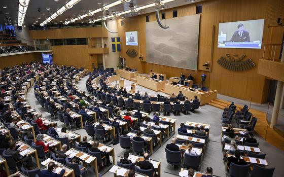 Lawmakers sit at the Swedish Parliament in Stockholm, Sweden, Wednesday March 22, 2023. Swedish lawmakers have overwhelmingly voted in favor of Sweden joining NATO with lawmakers signing off on membership along with the required legislation. The 349-seat Riksdagen, or parliament, on Wednesday voted 269-37 to clear the last required domestic hurdle to becoming part of the 30-member Western military alliance. (Anders Wiklund/TT News Agency via AP)