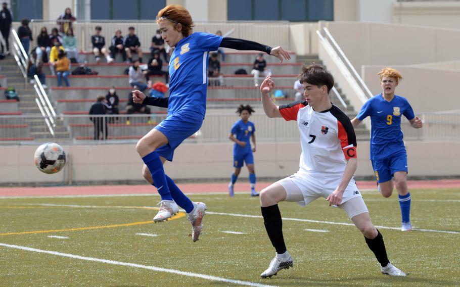 Yokota's Tommy Vogeley tries to field the ball in front of Nile C. Kinnick's Kuo Nishiyama during the championship match in the Perry Cup soccer tournament. Nishiyama had both goals as the Red Devils shut out the Panthers 2-0.