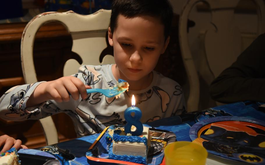 Daniel takes a bite of his birthday cake while celebrating his birthday with his American host family in Queidersbach, a village near Ramstein Air Base, Germany, March 16, 2022. Daniel, which is a pseudonym used to protect his family members still in Ukraine, and his family fled their home in Kyiv late last month.