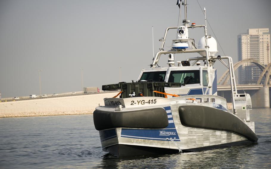 The doors of a green box containing an aerial drone open aboard an unmanned ship at Naval Support Activity Bahrain, Dec. 1, 2022. The ship, the Elbit Systems Seagull, uses a human pilot while navigating busy harbors. The aerial drone, the Easy Aerial SAMS-T, can fly above the ship while drawing power via a 300-foot cable.