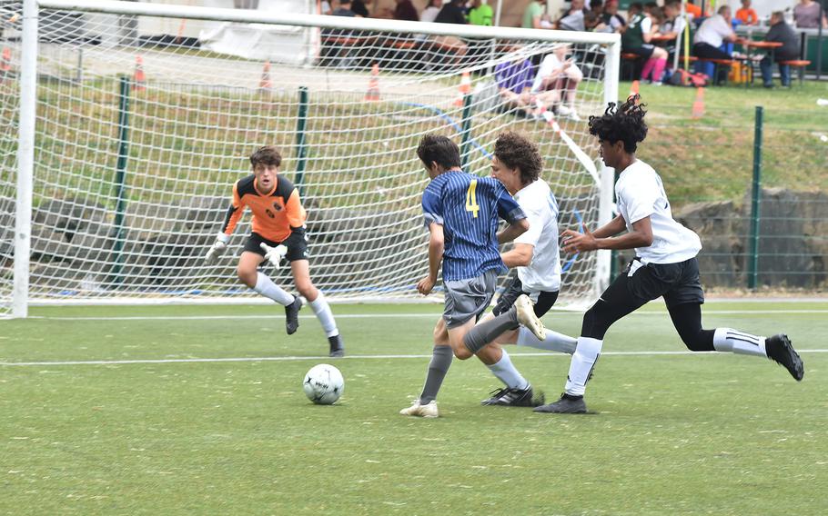 Brussels' goalkeeper Luke Heinbaugh awaits an onrushing Easton Brock from Anbach on Monday, May 16, 2022 at the DODEA-Europe boys Division III soccer championships at Reichenbach, Germany.