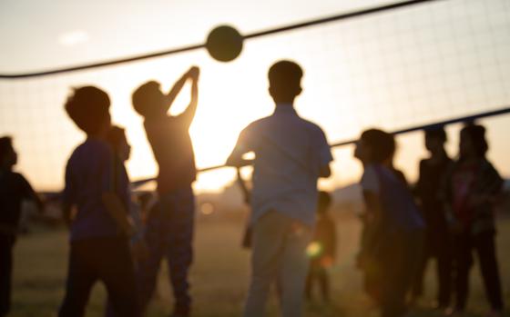 Children play volleyball.