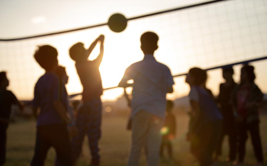 Children play volleyball.