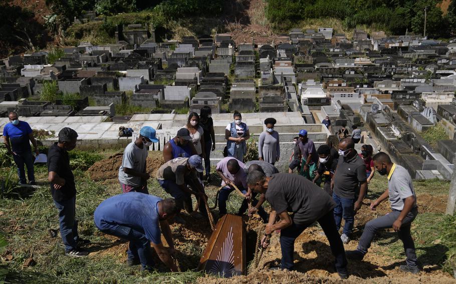 The remains of 54-year-old woman Zilmar Batista, who died in the mudslides, are buried at the Municipal cemetery in Petropolis, Brazil, Thursday, Feb. 17, 2022. 