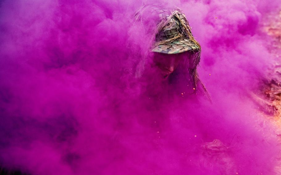 A U.S. Army Sniper School student undergoes the ghillie wash, which tests the durability of the camouflage suits that snipers wear in the field, at Fort Benning, Ga., Feb. 5, 2021.  A woman recently graduated for the first time from the seven-week sniper course, the Army announced.