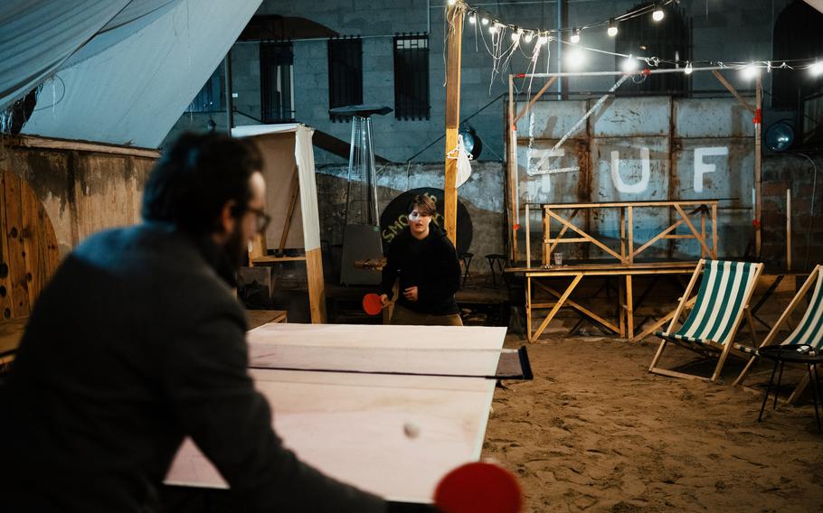 Patrons play ping-pong on Feb. 1 in the yard of Tuf, a bar established by Russian expatriates in Yerevan, Armenia.
