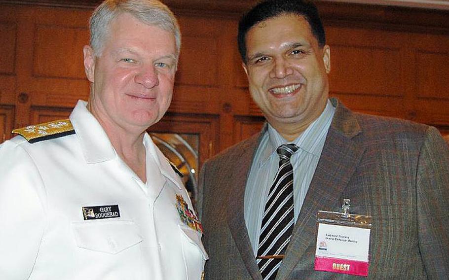 In this undated photo, former Chief of Naval Operations Adm. Gary Roughead poses with Leonard Glenn Francis, also known as "Fat Leonard," who admitted to bribing Navy officials with cash, luxury travel and prostitutes for classified or inside information that benefited his firm. Roughead was not implicated in the case.