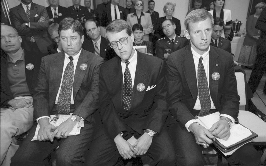 VMI alumni react to the 1996 vote by the college's Board of Visitors to remain public and accept women. Front row left to right and all wearing "Go Private" buttons: Doug Welty, Thornton Newlon, James Cottrell and Alan Soltis. 