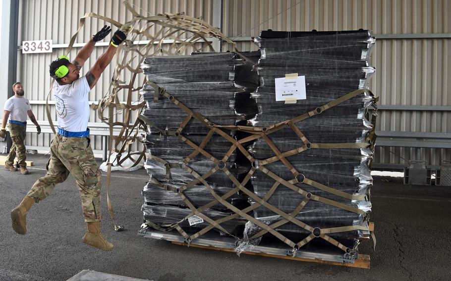 The team from Ramstein Air Base’s 721st Aerial Port Squadron throws webbing over a pallet during the Port Dawg Rodeo at the base, July 6, 2022.